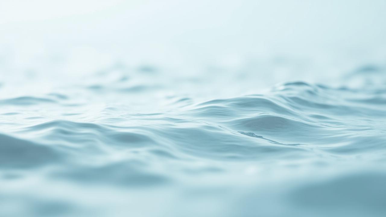 Soft-focus serene water and smooth stones representing calm skincare